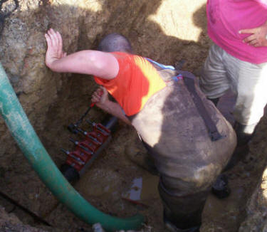 Employees of  the Ardmore Water System are shown repairing the leak on the day it was located.